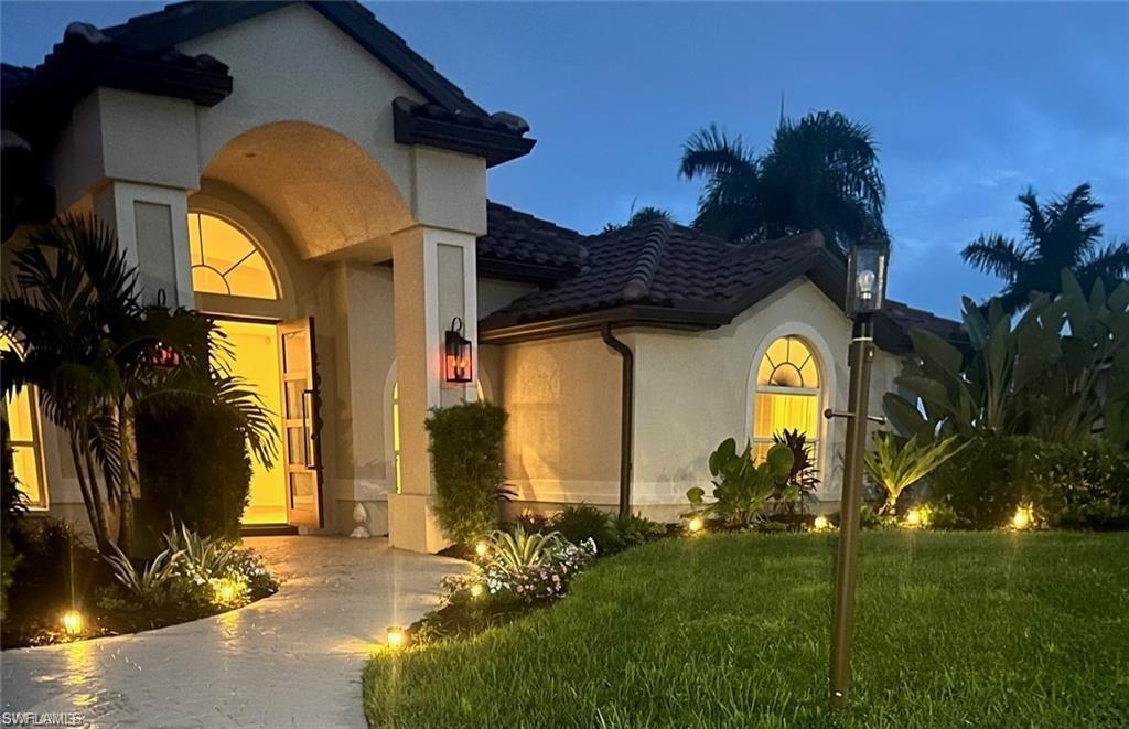 Image 2: Mediterranean / spanish house featuring stucco siding, a front yard, and a tile roof