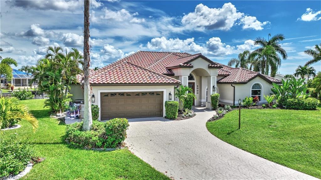 Image 4: Mediterranean / spanish home featuring a front lawn and a garage