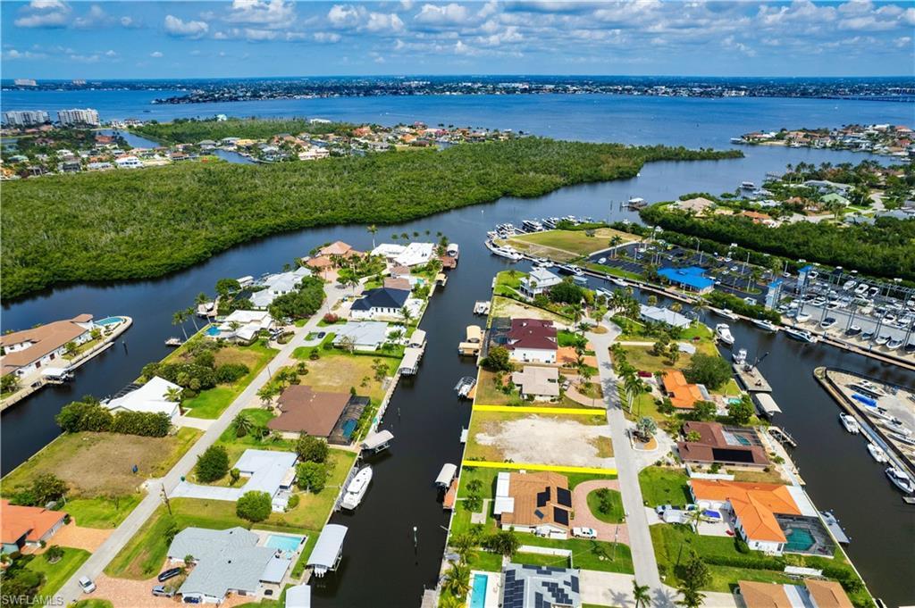Image 1: View of property location with a nearby body of water and nearby suburban area