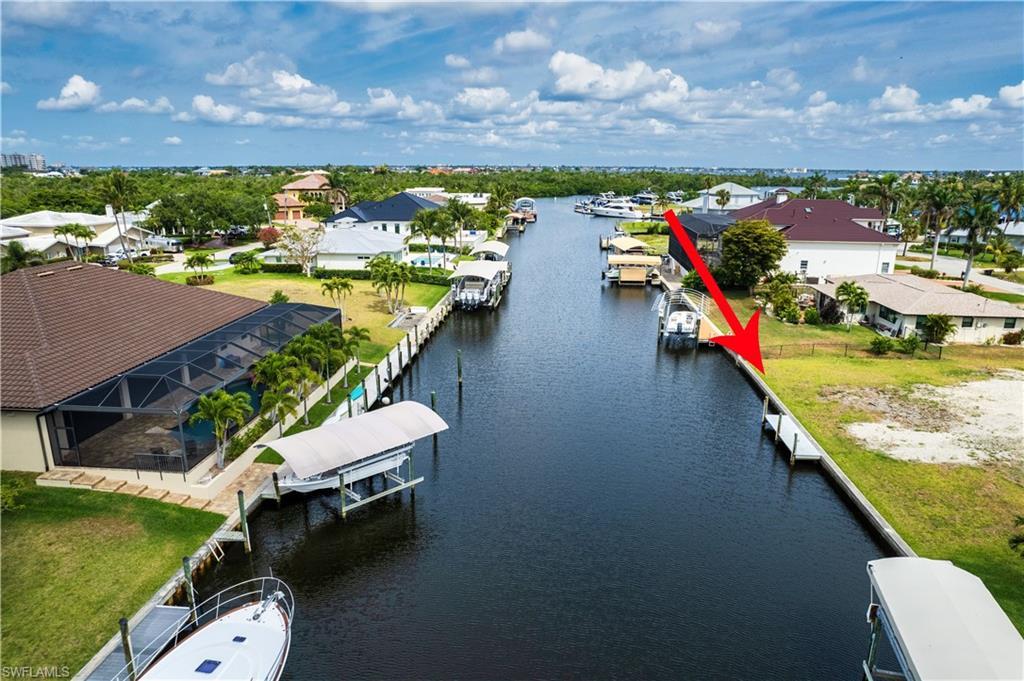 Image 2: Aerial view of residential area featuring a large body of water