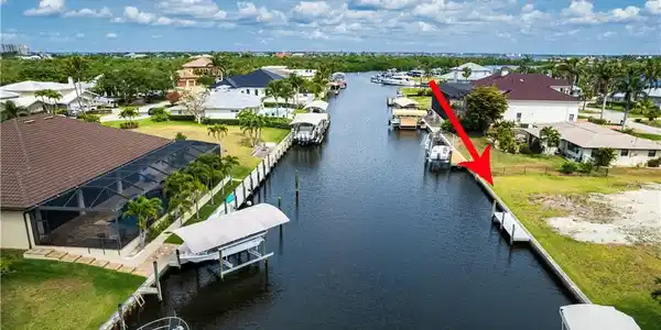 Image 2: Aerial view of residential area featuring a large body of water