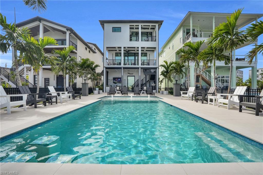 Image 3: Swimming pool with stairs, a patio area, and a balcony - Virtually Edited Image