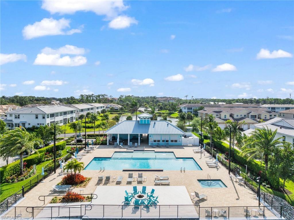Image 3: Community pool featuring a patio area and a residential view