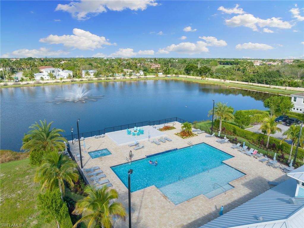 Image 4: Bird's eye view of a pool area and a nearby body of water