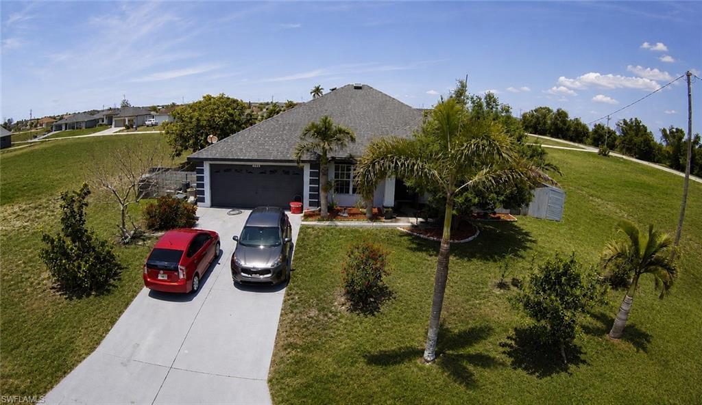 Image 1: Single-story residence featuring a gray shingle roof and a two-car garage