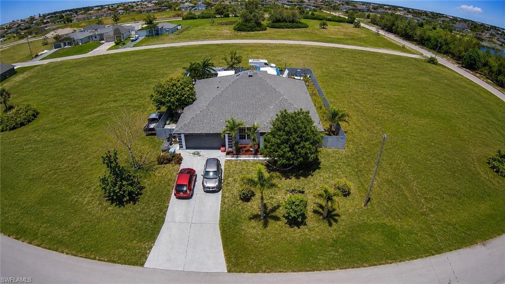 Image 2: Single-story residence with a gray shingle roof and an attached two-car garage