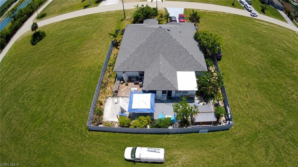 Image 3: Property featuring a gray shingle roof, a fenced perimeter, and a rear patio area