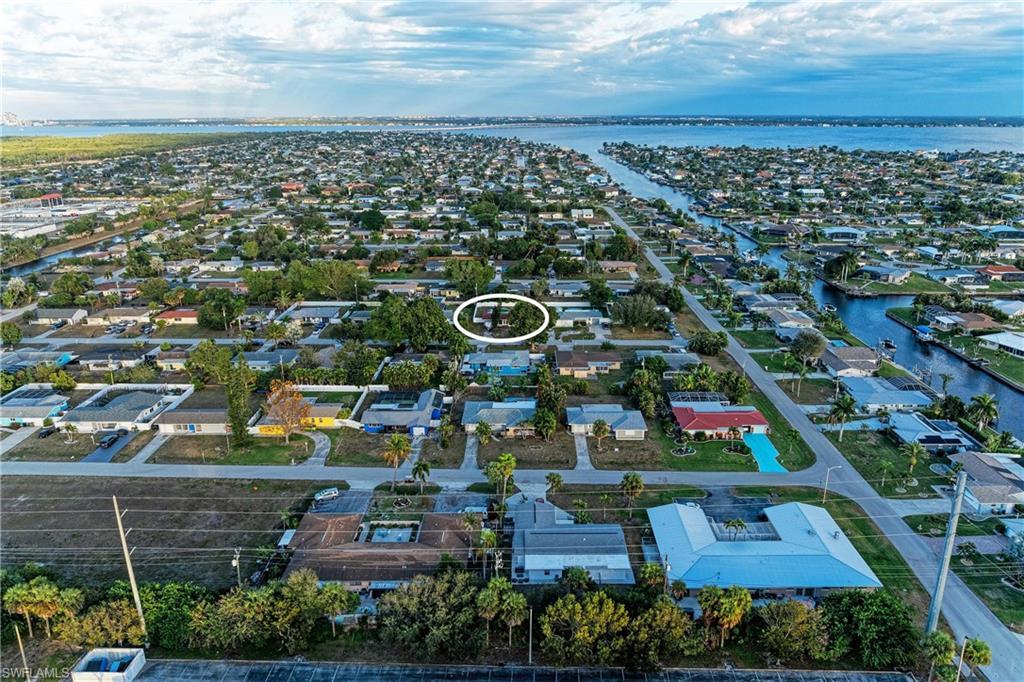 Image 1: Aerial perspective of suburban area featuring a large body of water
