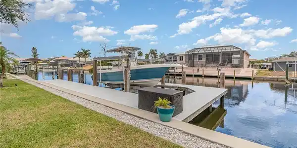 Image 2: Seeing is believing! 75' Seawall on a wide canal! Heavy duty boat lift & wrap-a-round composite dock!
