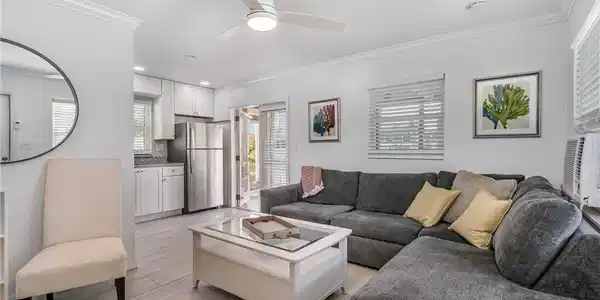 Image 4: Open living with light-toned tile flooring!