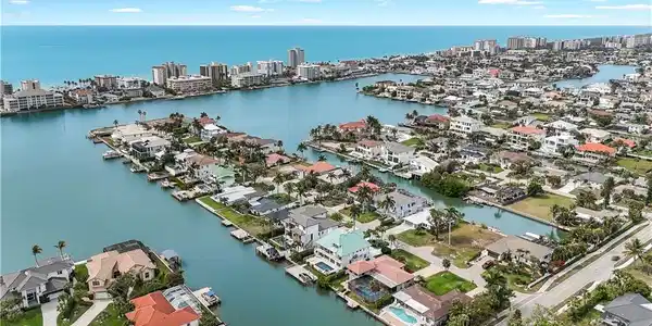 Image 3: View of urban area with a large body of water and nearby suburban area