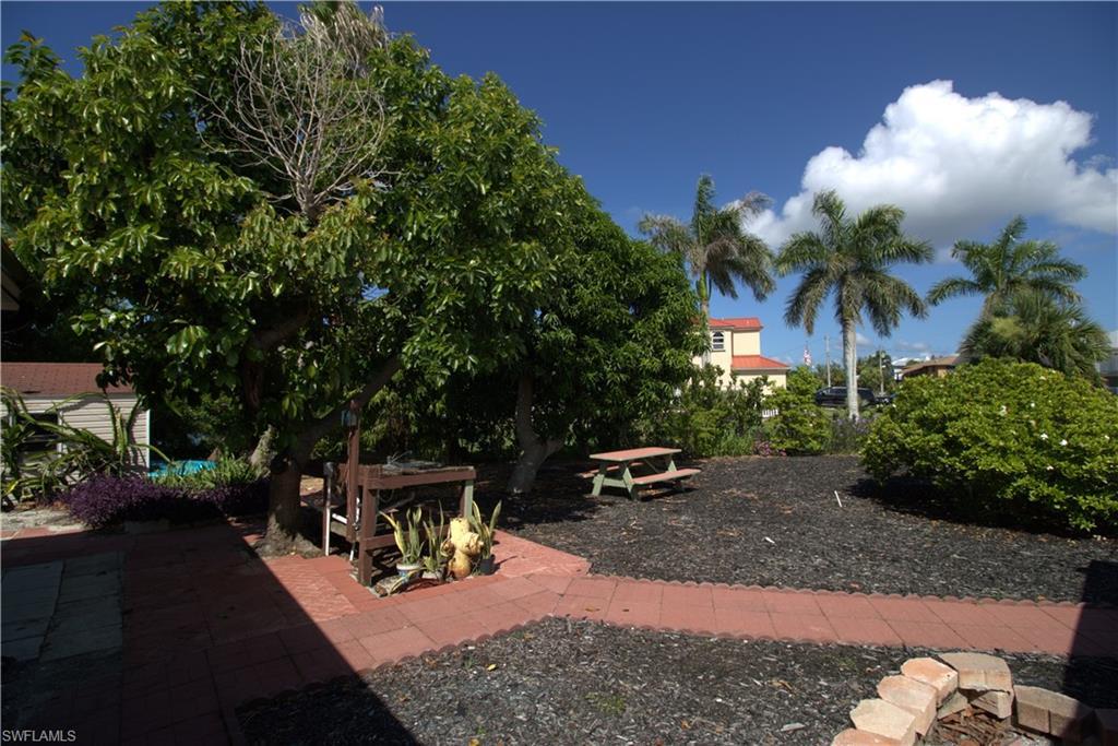 Image 3: View of front of property featuring driveway, a garage, a front yard, and a metal roof
