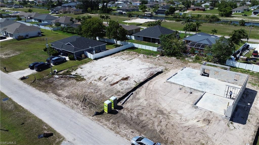 Image 4: Aerial perspective of suburban area with a nearby body of water