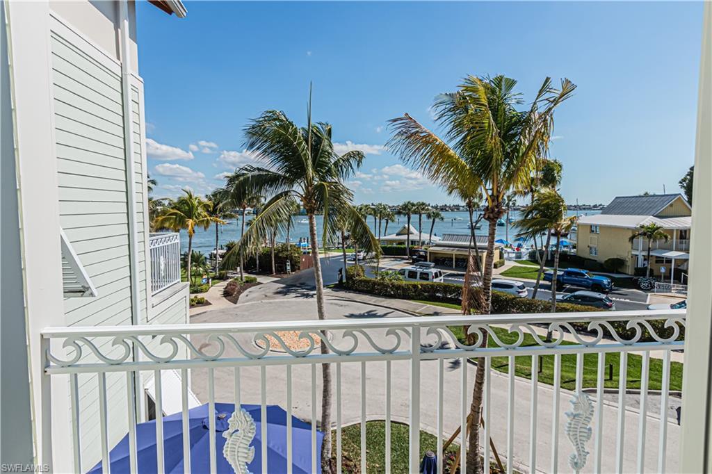 Image 1: Balcony featuring a water view