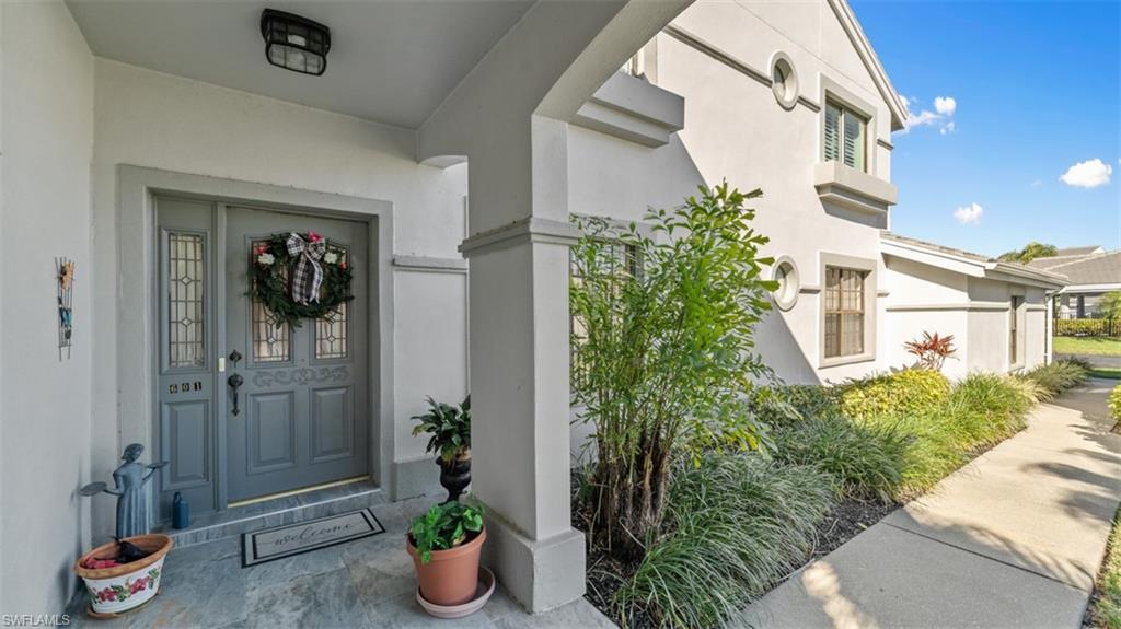 Image 2: Entrance to property with stucco siding