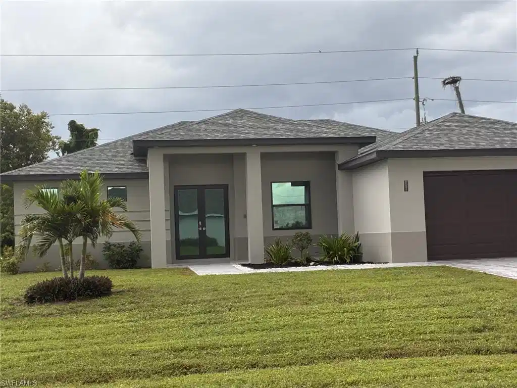 Image 1: Contemporary-style home featuring roof with shingles, stucco block, a front yard, and an attached garage