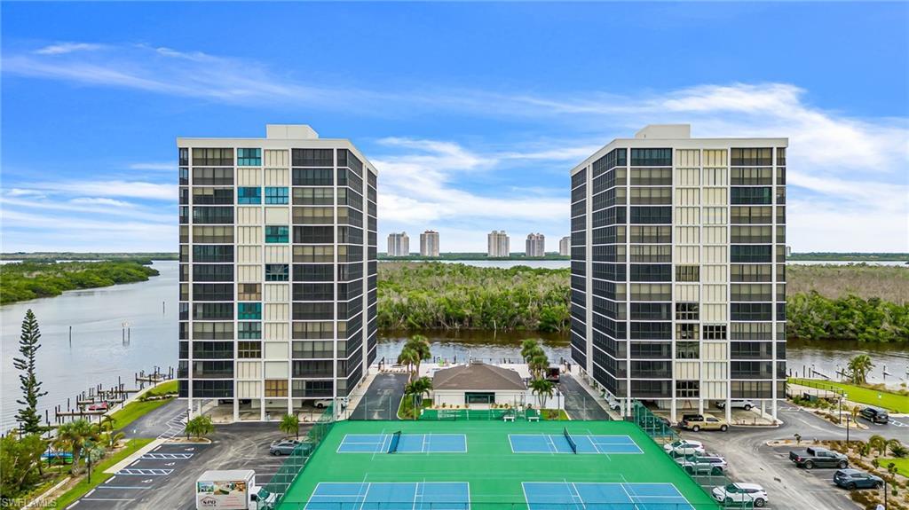 Image 3: View of building exterior featuring a water view