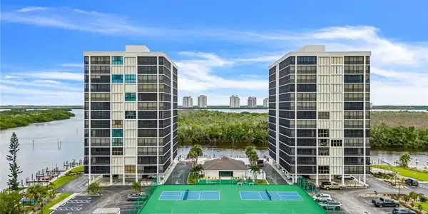 Image 3: View of building exterior featuring a water view