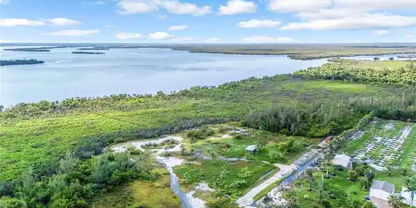 Image 3: Aerial overview of property's location with a nearby body of water