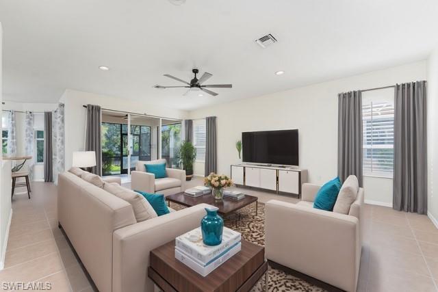 Image 3: Living area featuring light tile patterned floors, recessed lighting, visible vents, and a healthy amount of sunlight