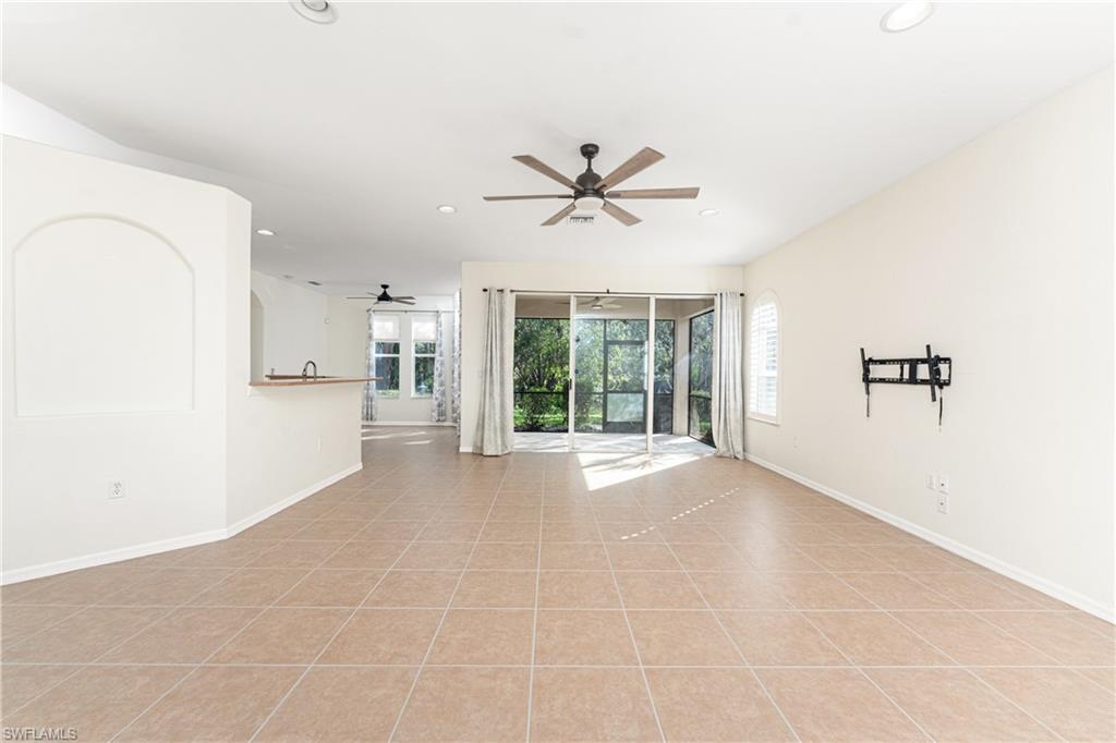 Image 4: Living room featuring light tile patterned floors, baseboards, and recessed lighting