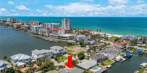 Image 2: Waterfront property featuring a private boat dock, pool, and direct canal access