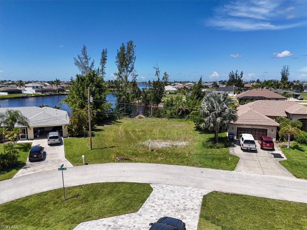 Image 4: View of property's community with a residential view, a water view, and a lawn