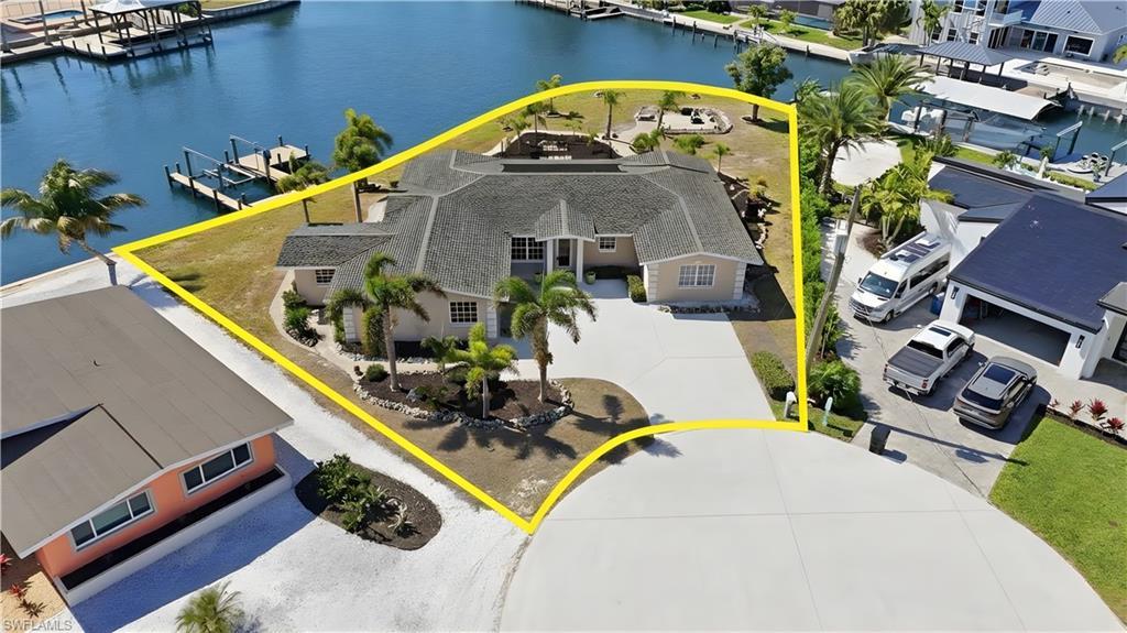 Image 3: Aerial view of residential area featuring a nearby body of water - Virtually Edited Image