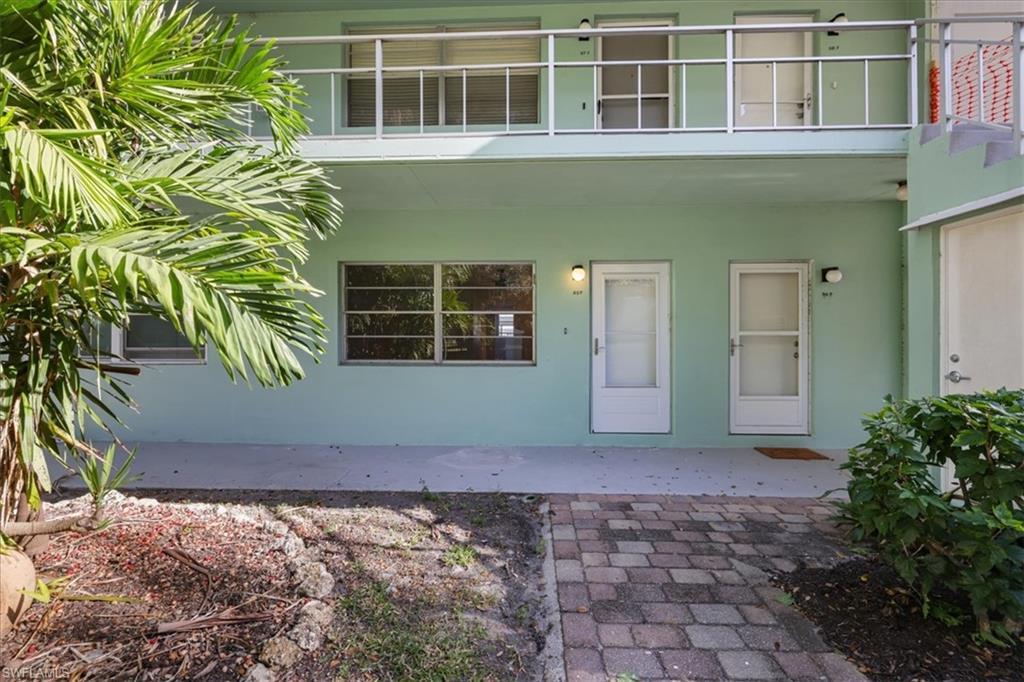 Image 3: Doorway to property featuring stucco siding and a patio