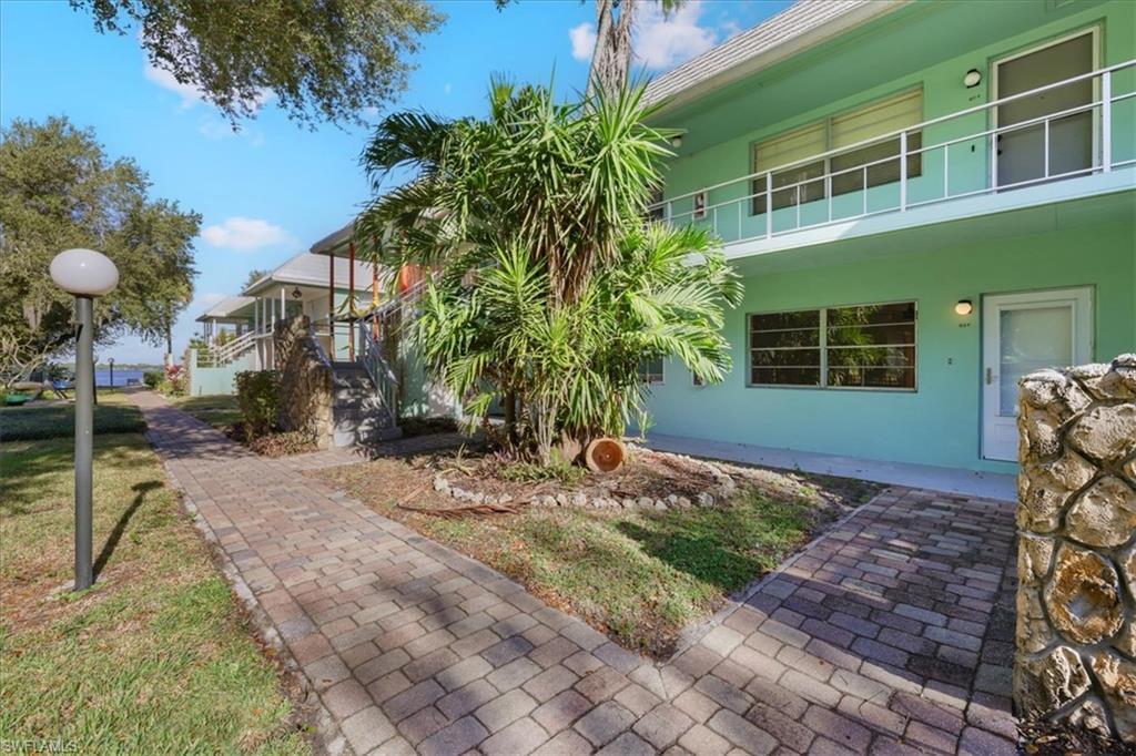 Image 4: View of home's exterior featuring stucco siding, a balcony, and a yard