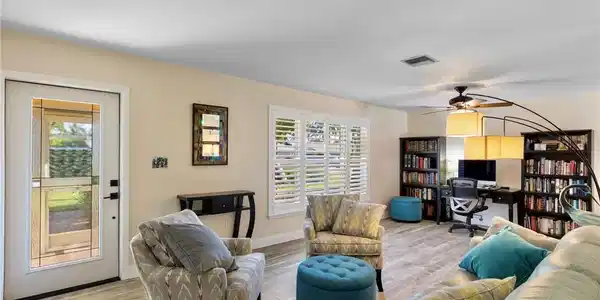 Image 4: Updated engineered hardwood flooring throughout the home, and plantation shutters in the living room