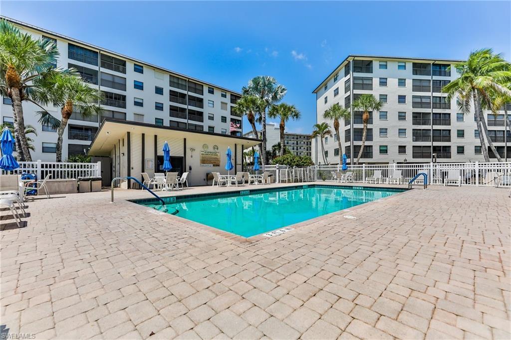 Image 1: View of pool featuring a patio area