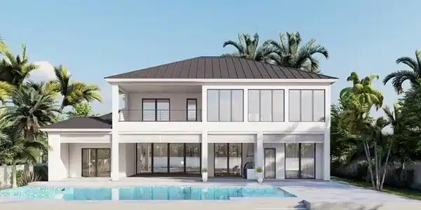 Image 4: Back of property with a patio area, a balcony, a metal roof, a standing seam roof, and an outdoor pool