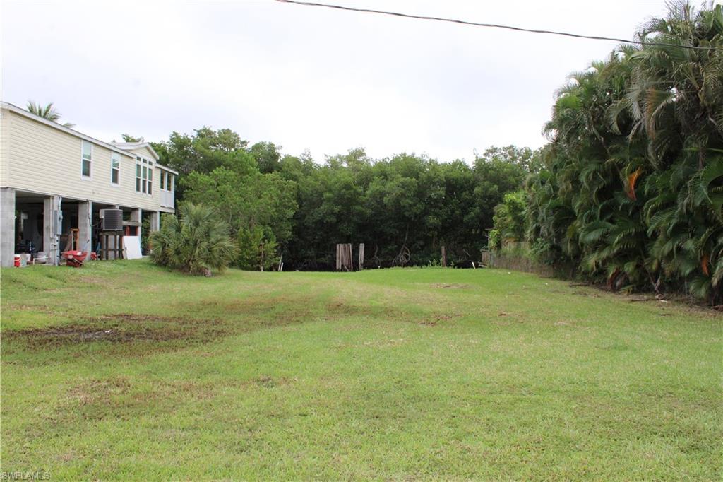 Image 3: View of grassy yard, facing the water.
