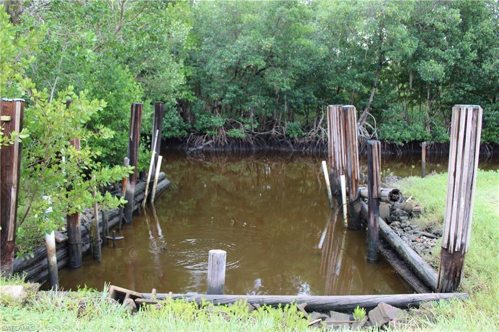 Image 4: Boat slip area with a view of trees and a water view.