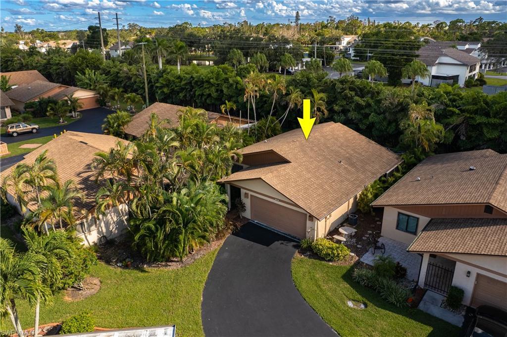 Image 2: Aerial view of residential area featuring a tree filled landscape