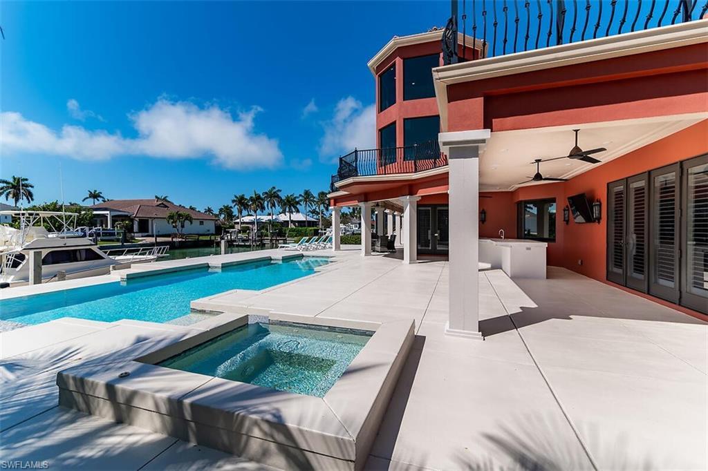 Image 4: Outdoor pool with ceiling fan, french doors, an in ground hot tub, and a patio area