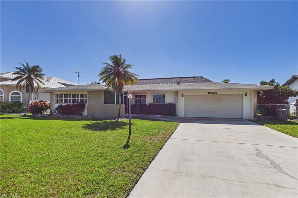Image 2: Ranch-style home with concrete driveway, a garage, and stucco siding