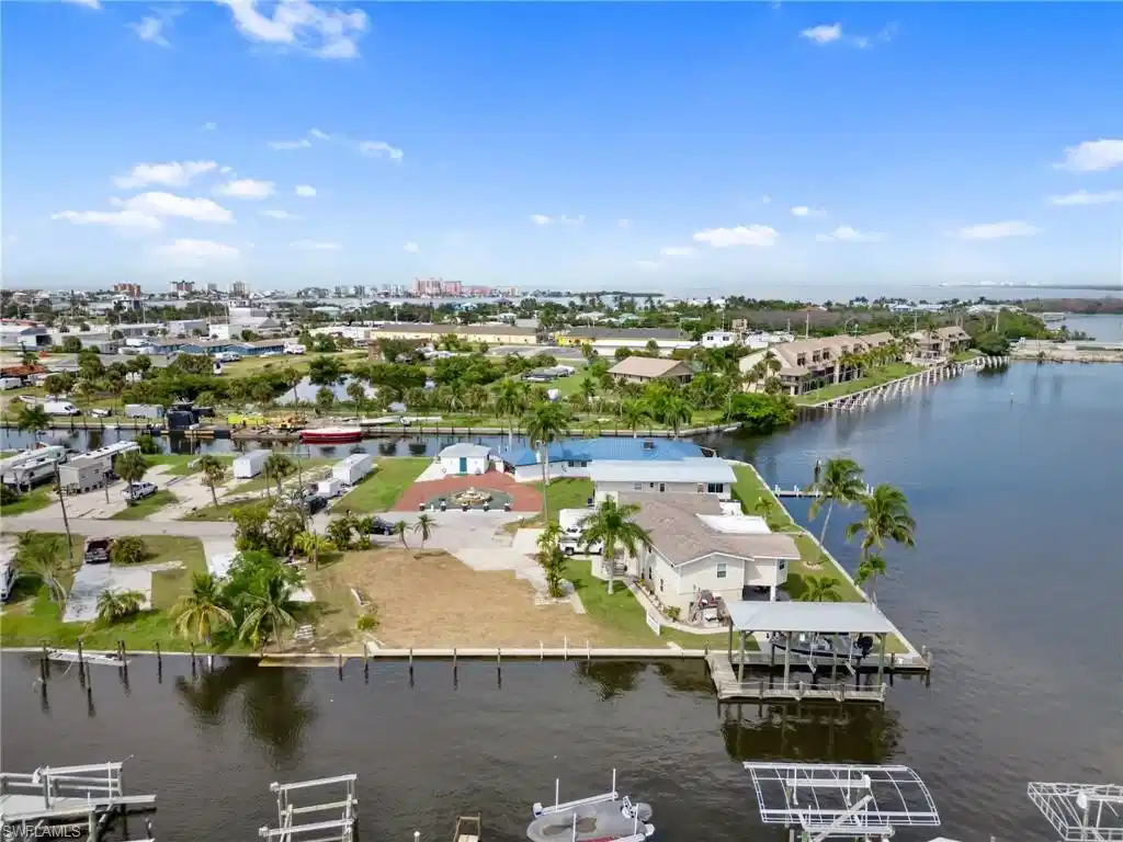 Image 1: Aerial view of residential area with a nearby body of water