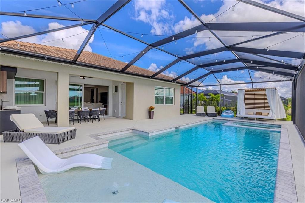 Image 2: View of pool with a patio, a lanai, a sunroom, and outdoor dining space