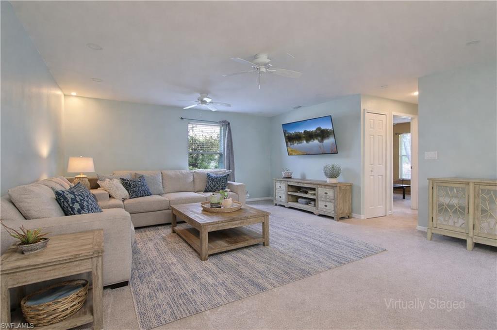 Image 3: Carpeted living area featuring recessed lighting, a window with exterior views, and a ceiling fan