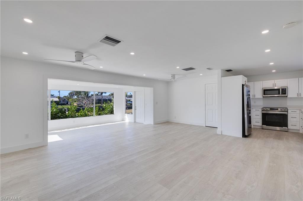 Image 3: Unfurnished living room featuring light wood-type flooring, a ceiling fan, and recessed lighting