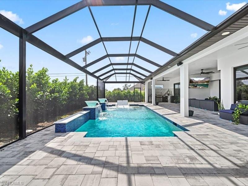Image 3: Swimming pool featuring a sunroom, a patio, and a lanai