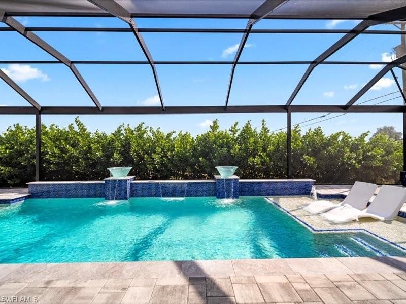 Image 4: Outdoor pool with glass enclosure, a sunroom, and a patio area pool size 13 x 33