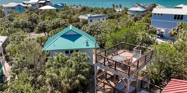 Image 4: Bird's eye view featuring a water view and a view of the beach