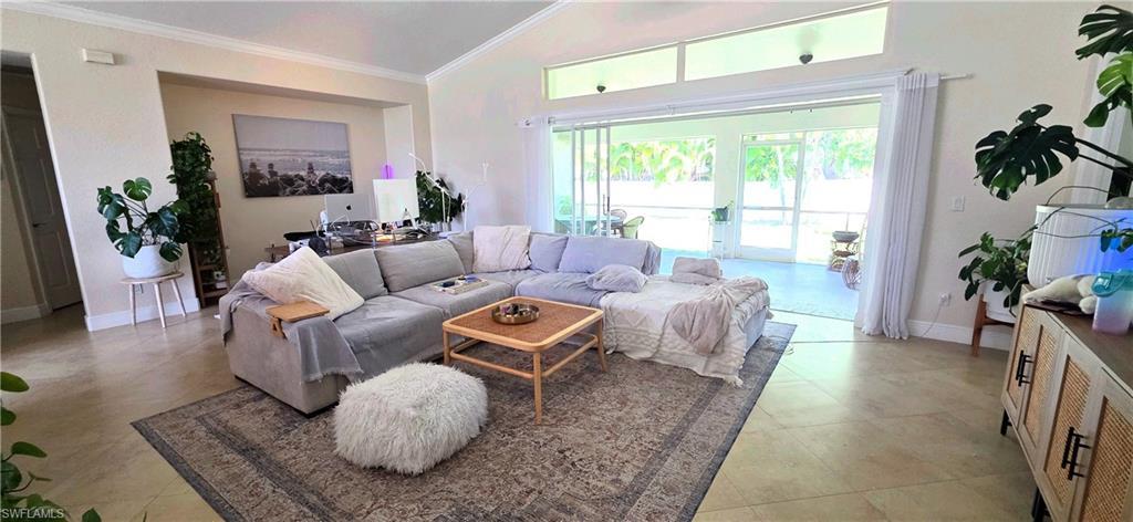 Image 3: Spacious living area featuring vaulted ceilings, clerestory windows, and light-toned tile flooring