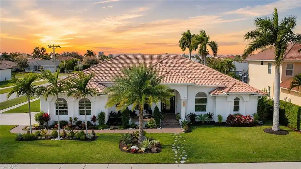 Image 1: Mediterranean-style residence featuring a tile roof and stucco exterior