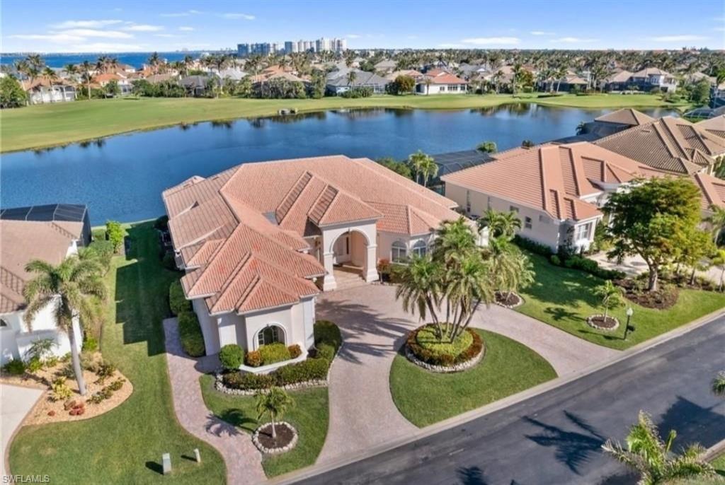 Image 1: Aerial perspective of suburban area with a nearby body of water
