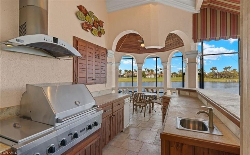 Image 4: View of patio / terrace with exterior kitchen and a water view
