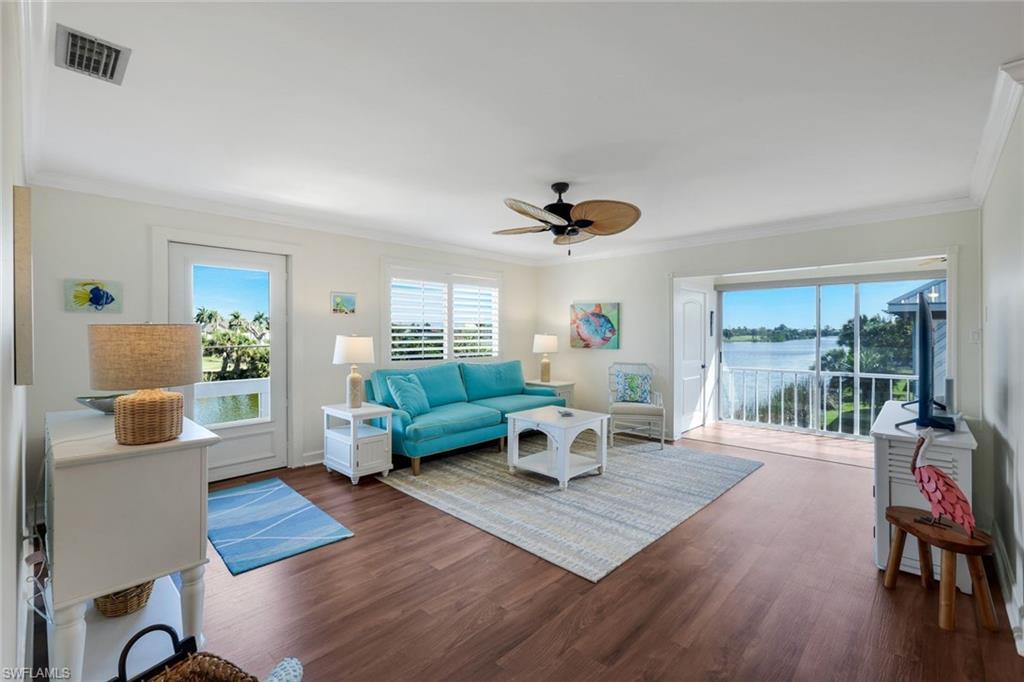Image 4: Living area featuring wood-finish flooring and crown molding
